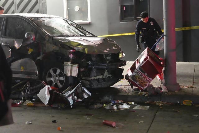 A vehicle sits on the sidewalk after ramming into a crowd of people waiting to enter a nightclub along a busy boulevard in Los Angeles early Saturday, July 19, 2025 injuring several people. (AP Photo/Damian Dovarganes)