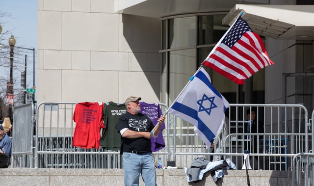 On Sunday afternoon a man holds an Israel and US flag outside the Convention Center in Washington, D.C. where the AIPAC conference is taken place. Washington, D.C. March 24, 2019. (Photo by Aurora Samperio/NurPhoto via Getty Images)