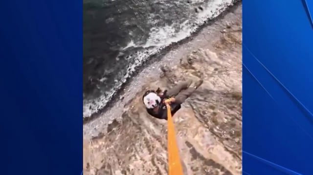 A Sonoma County Sheriff’s Department tactical flight officer conducts an aerial rescue in Point Reyes National Seashore. 