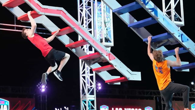 Two people dangling from staircases overhead