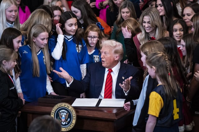President Donald Trump signs an executive order banning transgender athletes from participating in women's sports in the East Room at the White House on Wednesday, Feb 5, 2025. 