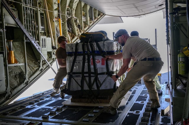 Pallets are loaded on a Royal Canadian Air Force CC-130 Hercules transport aircraft before airdropping some of approximately 21,600 lbs of humanitarian aid over the Gaza Strip, at Queen Alia International Airport in Amman, Jordan August 4, 2025.  Corporal Marc-Andre Leclerc/Canadian Forces/Handout via REUTERS