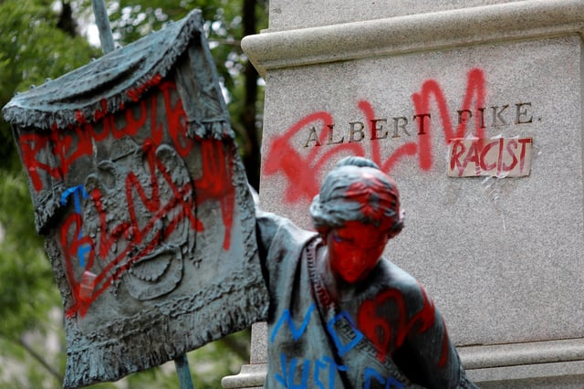 Messages of protest remain after protesters toppled the statue of Albert Pike, amid a series of racial inequality protests, at the Brigadier General Albert Pike Statue site near Capitol Hill in Washington, U.S., July 7, 2020. REUTERS/Tom Brenner/File Photo