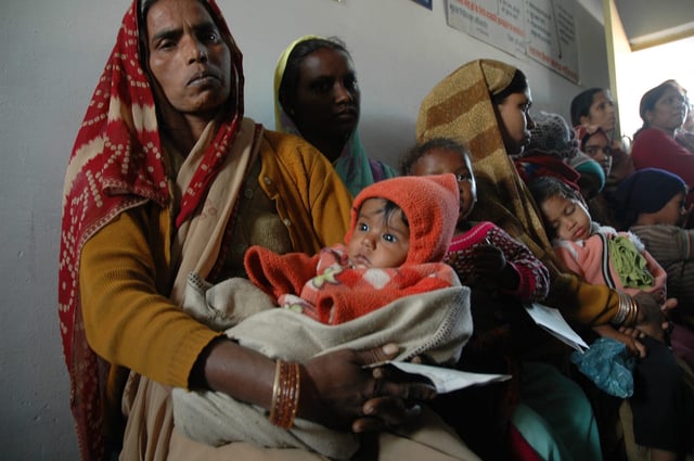 Women in India wait in line for vaccinations at a Gates Foundation-funded clinic.