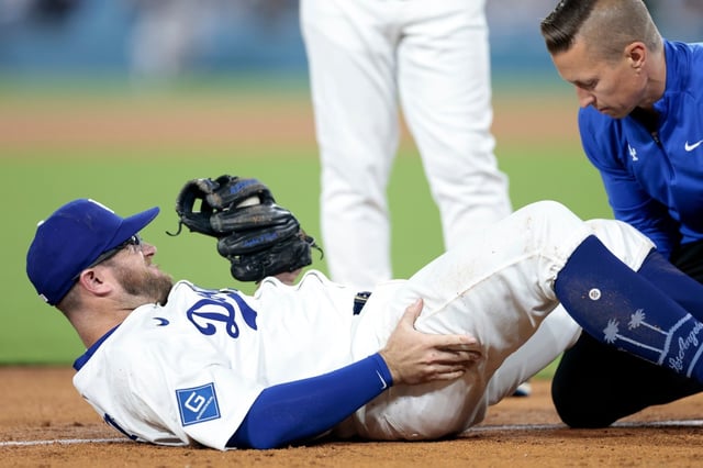 Max Muncy of the Dodgers reacts as he is checked out by the trainer after being injured during the sixth inning against the Chicago White Sox at Dodger Stadium on July 2, 2025 in Los Angeles. (Photo by Ronald Martinez/Getty Images)