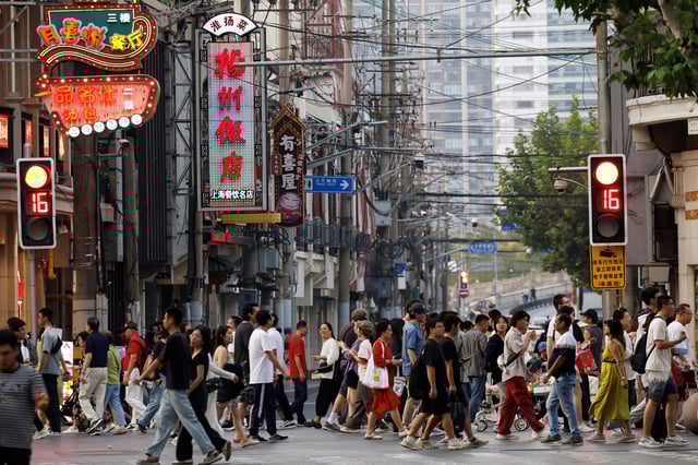 People walk past a lane lined up with restaurants, at a shopping area in Shanghai, China September 28, 2024. REUTERS/Tingshu Wang/ File Photo