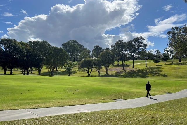 A man walks at the Victoria Park-Barrambin, where the main stadium will be built for the 2032 Olympics, in Brisbane, Australia July 21, 2025. REUTERS/Nick Mulvenney/File Photo