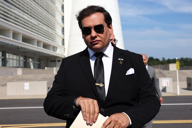 WEST ISLIP, NEW YORK - AUGUST 19: Former U.S. Rep. George Santos prepares to give a statement after a court hearing on August 19, 2024 in West Islip, New York. Santos pleaded guilty to wire fraud and aggravated identity theft weeks before his federal trial was set to begin. His sentencing has been scheduled for February 7, and he faces more than six years in prison under federal sentencing guidelines. Santos owes at least $370,000 in restitution. He was expelled from Congress in 2023, becoming the sixth member in the chamber’s history to be ousted by colleagues. (Photo by Michael M. Santiago/Getty Images)