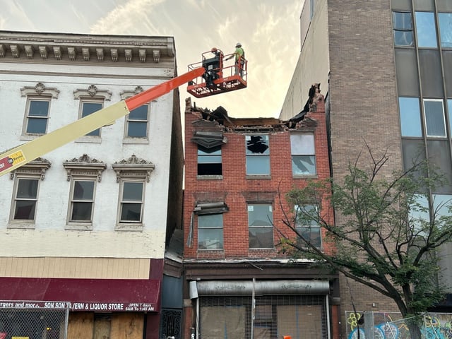 The demolition of the collapsed building on North Eutaw street has begun as construction crews begin with the top of the building. (Chevall Pryce/Staff)