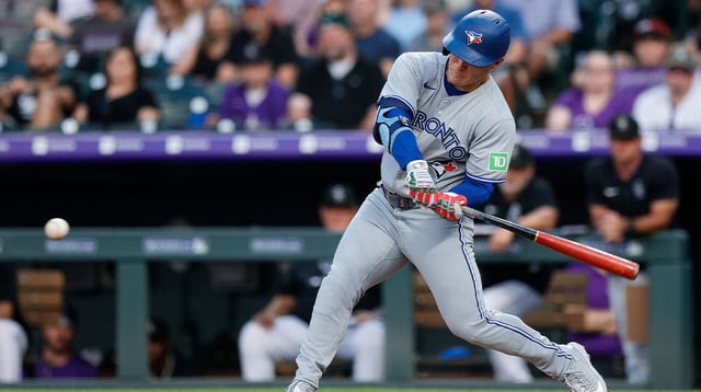 Aug 4, 2025; Denver, Colorado, USA; Toronto Blue Jays center fielder Daulton Varsho (5) hits a three run home run in the third inning against the Colorado Rockies at Coors Field. Mandatory Credit: Isaiah J. Downing-Imagn Images