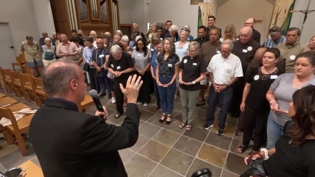 A blessing takes place on Aug. 4, 2025, at the San Diego Diocese’s Pastoral Center for the roughly 50 volunteers supporting asylum seekers during their immigration hearings.