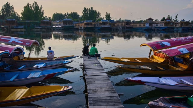 A group of Kashmiri men fish on Dal Lake in Srinagar. (AP file)