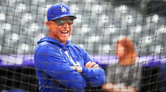 Jun 25, 2025; Denver, Colorado, USA; Los Angeles Dodgers manager Dave Roberts (30) watches warmups before the game against the Colorado Rockies at Coors Field. Mandatory Credit: Christopher Hanewinckel-Imagn Images