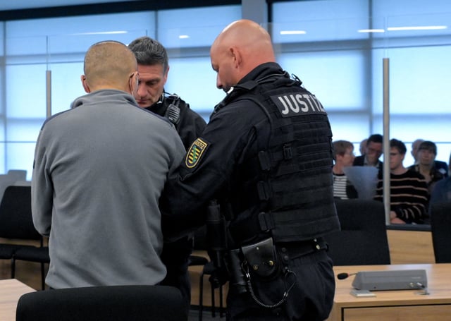 Defendant Jian G., a former assistant to then-member of the European Parliament Maximilian Krah, of the far-right Alternative for Germany (AFD) party, arrives at the courtroom for a high-profile espionage trial, in Dresden, Germany, August 5, 2025. REUTERS/Matthias Rietschel