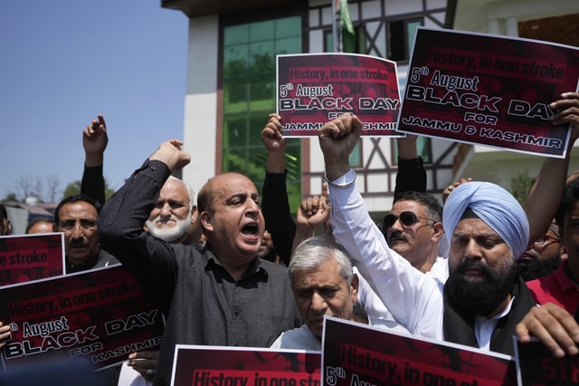 Supporters of India's opposition Congress party shout slogans demanding the ruling government restore the statehood of the disputed region, in Srinagar, Indian-controlled Kashmir, Tuesday, Aug 5, 2025. (AP Photo/Mukhtar Khan)