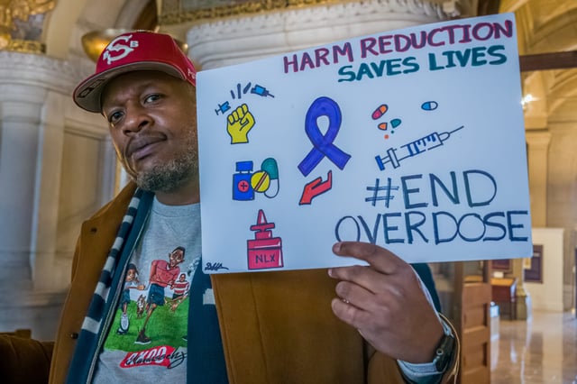 A participant is seen at the New York State Capitol at an overdose prevention event in 2023 urging lawmakers to implement harm reduction strategies.