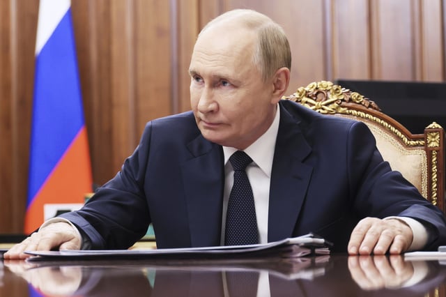 Russian President Vladimir Putin speaks with the head of the Russian-controlled Donetsk region Denis Pushilin during their meeting at the Kremlin in Moscow, Russia, Monday, Aug. 4, 2025. 