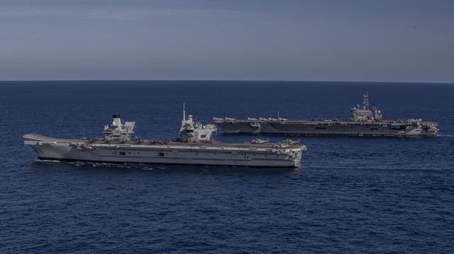 The British aircraft carrier HMS Prince of Wales, front, and the United States aircraft carrier USS George Washington, back, sail in formation in the Timor Sea on July 18, 2025.