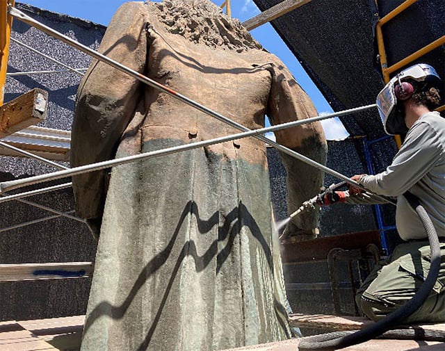 Micro-abrasive cleaning of the Albert Pike statue to remove corrosion and paint in order to review the conditions of the bronze prior to repairs