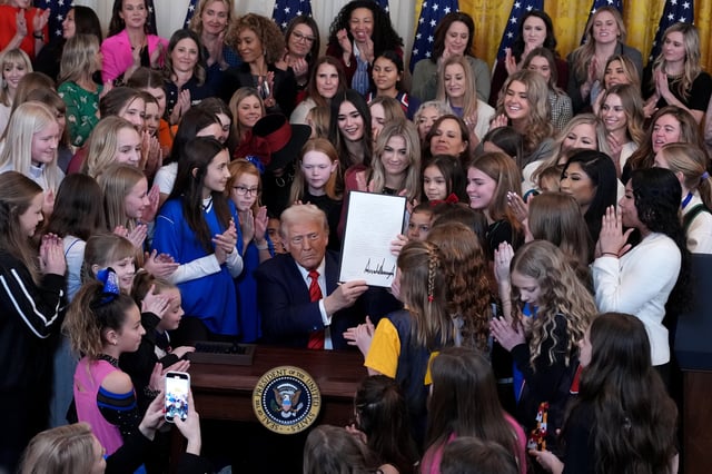 U.S. President Donald Trump is joined by female athletes as he signs the “No Men in Women’s Sports” executive order in the East Room at the White House on February 5, 2025 in Washington, DC.