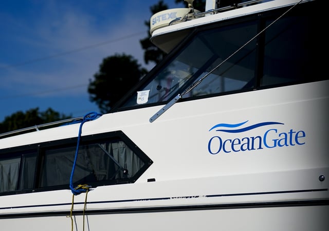 A boat with the OceanGate logo is parked on a lot near the OceanGate offices on June 22, 2023, in Everett, Wash. The U.S. Coast Guard said Thursday that the missing submersible Titan imploded near the Titanic shipwreck site, killing everyone on board. (AP Photo/Lindsey Wasson)
