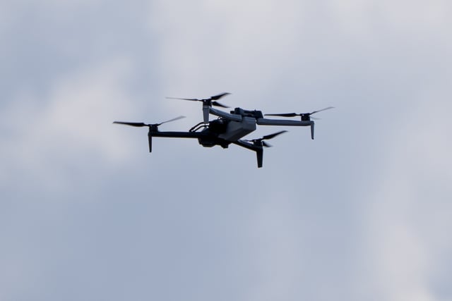 FILE - A law enforcement drone hovers before President Donald Trump departs in his motorcade from the Trump International Golf Club, Saturday, March 1, 2025, in West Palm Beach, Fla. (AP Photo/Alex Brandon, File)