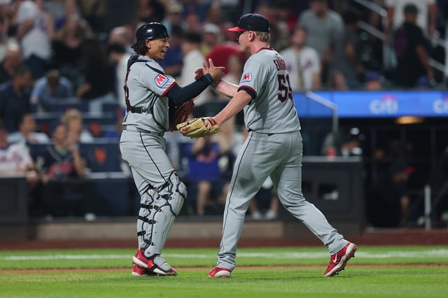 NEW YORK, NEW YORK - AUGUST 04: Nic Enright #59 and Bo Naylor #23 of the Cleveland Guardians celebrate a 7-6 victory in 10 innings over the New York Mets at Citi Field on August 04, 2025 in New York City. (Photo by Dustin Satloff/Getty Images)