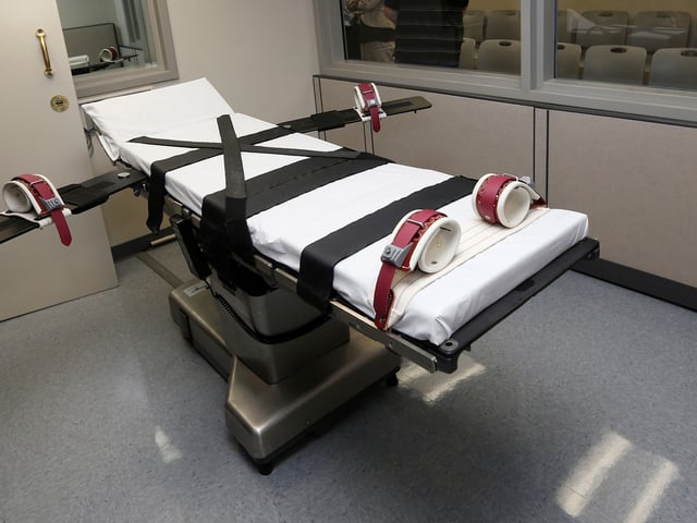 FILE - This Oct. 9, 2014, file photo shows the gurney in the the execution chamber at the Oklahoma State Penitentiary in McAlester, Okla. A 60-year-old Oklahoma man who stabbed a prison cafeteria worker to death in 1998 is scheduled to receive a lethal injection Thursday, Oct. 28, 2021 in the state's first attempt to administer the death penalty since a series of flawed executions more than six years ago. The state was moving forward with John Marion Grant's lethal injection after the U.S. Supreme Court, in a 5-3 decision, lifted stays of execution that were put in place on Wednesday for Grant and another death row inmate, Julius Jones, by the 10th U.S. Circuit Court of Appeals. (AP Photo/Sue Ogrocki, File)