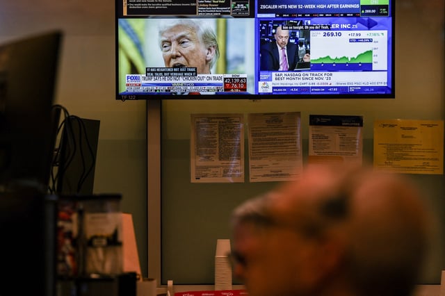 A screen shows U.S. President Donald Trump, as a futures-options trader works on the floor of the the New York Stock Exchange (NYSE) in New York City, U.S., May 30, 2025. REUTERS/Jeenah Moon/File photo