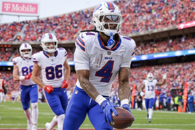James Cook #4 of the Buffalo Bills reacts after scoring a touchdown during the first half of the game against the Kansas City Chiefs at GEHA Field at Arrowhead Stadium on December 10, 2023 in Kansas City, Missouri.
