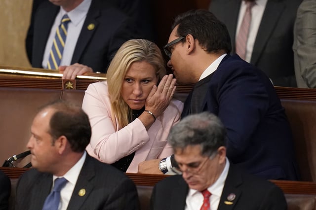 FILE - Rep.-elect George Santos, R-N.Y., right, talks with Rep. Marjorie Taylor Greene, R-Ga., during the ninth vote in the House chamber as the House meets for the third day to elect a speaker and convene the 118th Congress in Washington, Thursday, Jan. 5, 2023. (AP Photo/Alex Brandon, File)