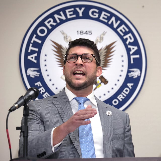 Florida Attorney General James Uthmeier, a white man wearing a suit and glasses