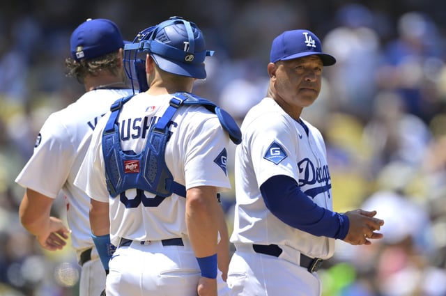 LOS ANGELES, CALIFORNIA - JULY 20: Dave Roberts #30 of the Los Angeles Dodgers pulls Clayton Kershaw #22 as Dalton Rushing #68 looks on in the fifth inning against the Milwaukee Brewers at Dodger Stadium on July 20, 2025 in Los Angeles, California.