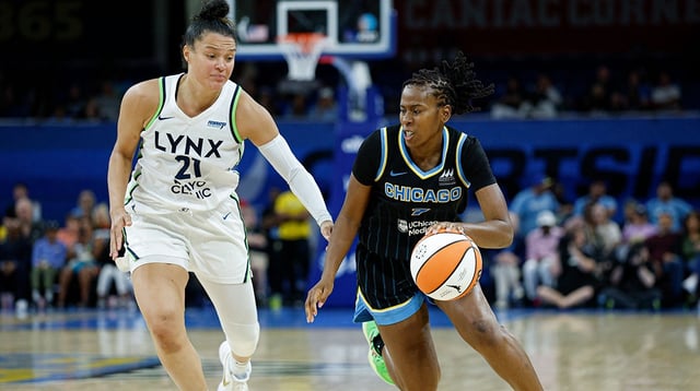 Jul 12, 2025; Chicago, Illinois, USA; Chicago Sky guard Ariel Atkins (7) drives to the basket against Minnesota Lynx guard Kayla McBride (21) during the second half of a WNBA game at Wintrust Arena. Mandatory Credit: Kamil Krzaczynski-Imagn Images