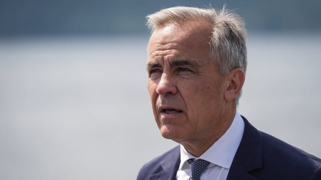 Prime Minister Mark Carney listens while touring the Royal Canadian Navy torpedo recovery vessel Sikanni at the Canadian Forces Maritime Experimental and Test Ranges (CFMETR), in Nanoose Bay, B.C., on Monday, Aug. 4, 2025. THE CANADIAN PRESS/Darryl Dyck