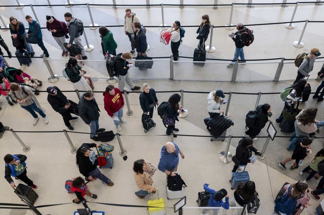 Travelers line up to enter security checkpoints at San Francisco International Airport. The CDC is urging international travelers to take precautions as a chikungunya virus outbreak in China’s Guangdong province infects over 7,000 people.