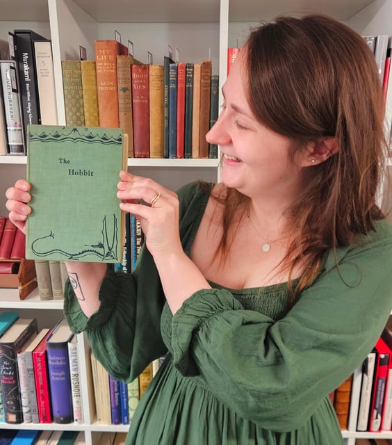 Caitlin Riley holds JRR Tolkein's The Hobbit. Photo courtesy Auctioneum.