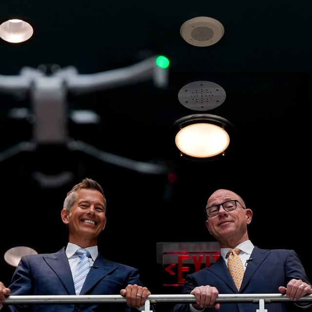 Transportation Secretary Sean Duffy, left, and Federal Aviation Administration administrator Bryan Bedford, right, watch a drone flight demonstration following a news conference on new drone regulations, Tuesday, Aug. 5, 2025, in the atrium of the Department of Transportation in Washington. (AP Photo/Julia Demaree Nikhinson)