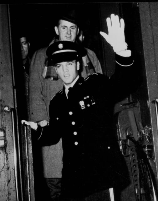 The famous photo of Elvis Presley arriving in Memphis on March 7, 1960, following his Army discharge. Colonel Tom Parker's family in Holland got quite the shock when they spotted him standing behind Elvis.