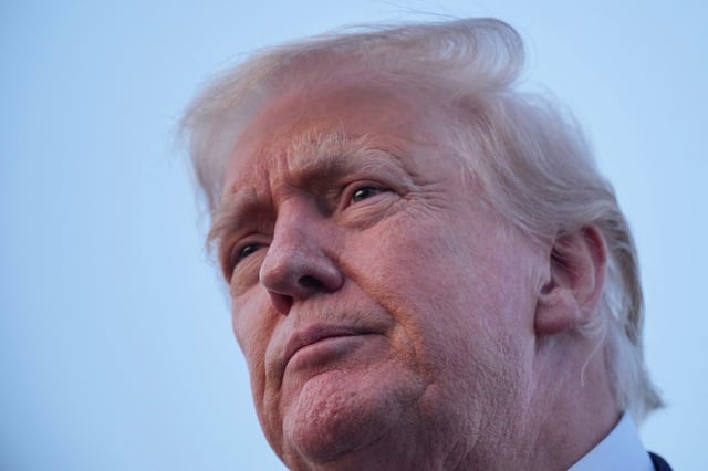 U.S. President Donald Trump looks on as he talks to members of the press at Lehigh Valley International Airport in Allentown, Pennsylvania, U.S., August 3, 2025. REUTERS/Ken Cedeno/File Photo