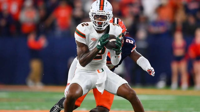 Nov 30, 2024; Syracuse, New York, USA; Miami Hurricanes wide receiver Isaiah Horton (2) catches the ball against Syracuse Orange linebacker Marlowe Wax (2) during the second half at the JMA Wireless Dome. Mandatory Credit: Rich Barnes-Imagn Images