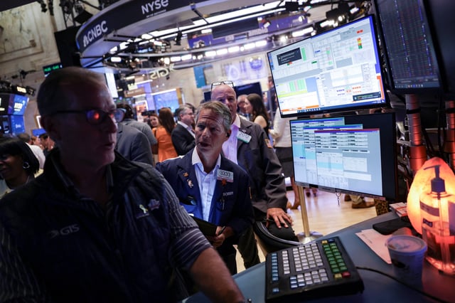 Traders work on the floor at the New York Stock Exchange (NYSE) in New York City, U.S., July 30, 2025. REUTERS/Jeenah Moon/File Photo