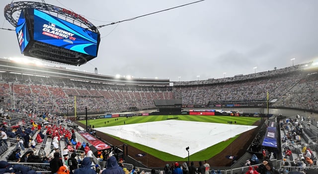 Aug 2, 2025; Bristol, Tennessee, USA; The tarp is on the field as rain delays the start of the Speedway Classic game between the Cincinnati Reds and the Atlanta Braves at Bristol Motor Speedway. Mandatory Credit: Bryan Lynn-Imagn Images