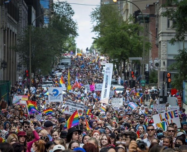 The head of Montreal's LGBTQ+ pride festival organization says the city's pride parade will go on as planned Sunday after its abrupt cancellation last year. Thousands turned out to walk in the Montreal Pride parade, Sunday, Aug. 15, 2021. THE CANADIAN PRESS/Peter McCabe