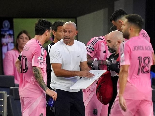 Inter Miami coach Javier Mascherano talks to forward Lionel Messi (10) on the sideline during a hydration break, in the first half of a Leagues Cup group stage soccer match against Atlas, Wednesday, July 30, 2025, in Fort Lauderdale, Fla. (AP Photo/Rebecca Blackwell)