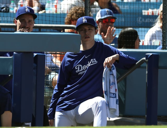 LOS ANGELES, CALIFORNIA - JULY 06: Rōki Sasaki #11 of the Los Angeles Dodgers with Blake Snell #7 watch from the dugout during the game between the Houston Astros and the Los Angeles Dodgers at Dodger Stadium on July 06, 2025 in Los Angeles, California.