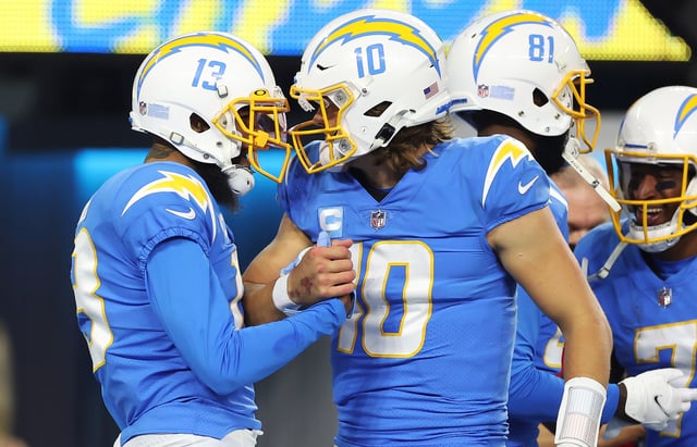 Keenan Allen #13 of the Los Angeles Chargers and Justin Herbert #10 of the Los Angeles Chargers celebrate after a touchdown against the Kansas City Chiefs during the fourth quarter at SoFi Stadium on December 16, 2021 in Inglewood, California.