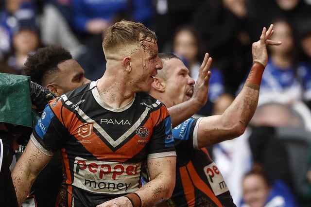 Brent Naden, right, celebrates a Tigers try during the round 22 match. He is set to be fined for the gesture.