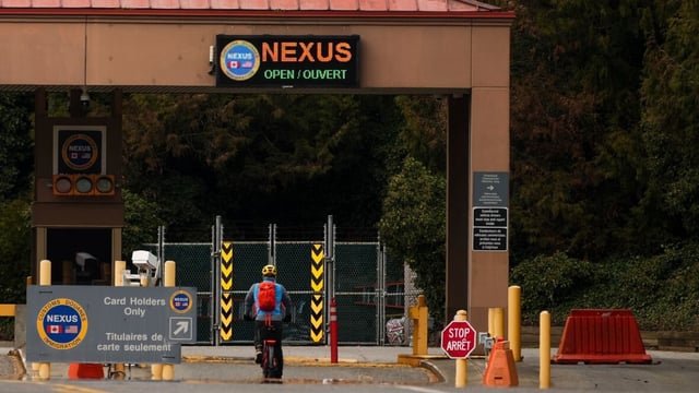 A bicyclist approaches the Nexus lane at the border crossing into Delta, B.C., on March 18. A recent policy change in the U.S. means Canadian applicants to the Nexus program will no longer be able to choose 'X' as a gender marker.