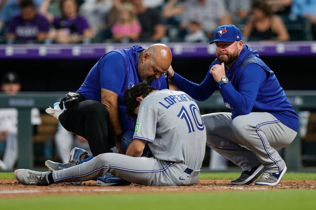 Aug 5, 2025; Denver, Colorado, USA; Toronto Blue Jays left fielder Joey Loperfido (C) is tended to by head athletic trainer Jose Ministral (L) and manager John Schneider (R) in the sixth inning against the Colorado Rockies at Coors Field. Mandatory Credit: Isaiah J. Downing-Imagn Images